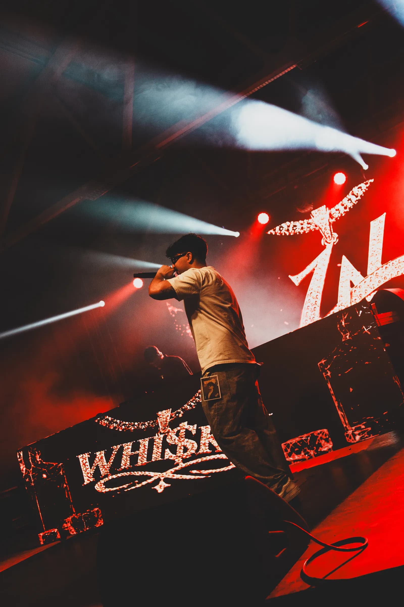 WHI$KY on stage under red lights