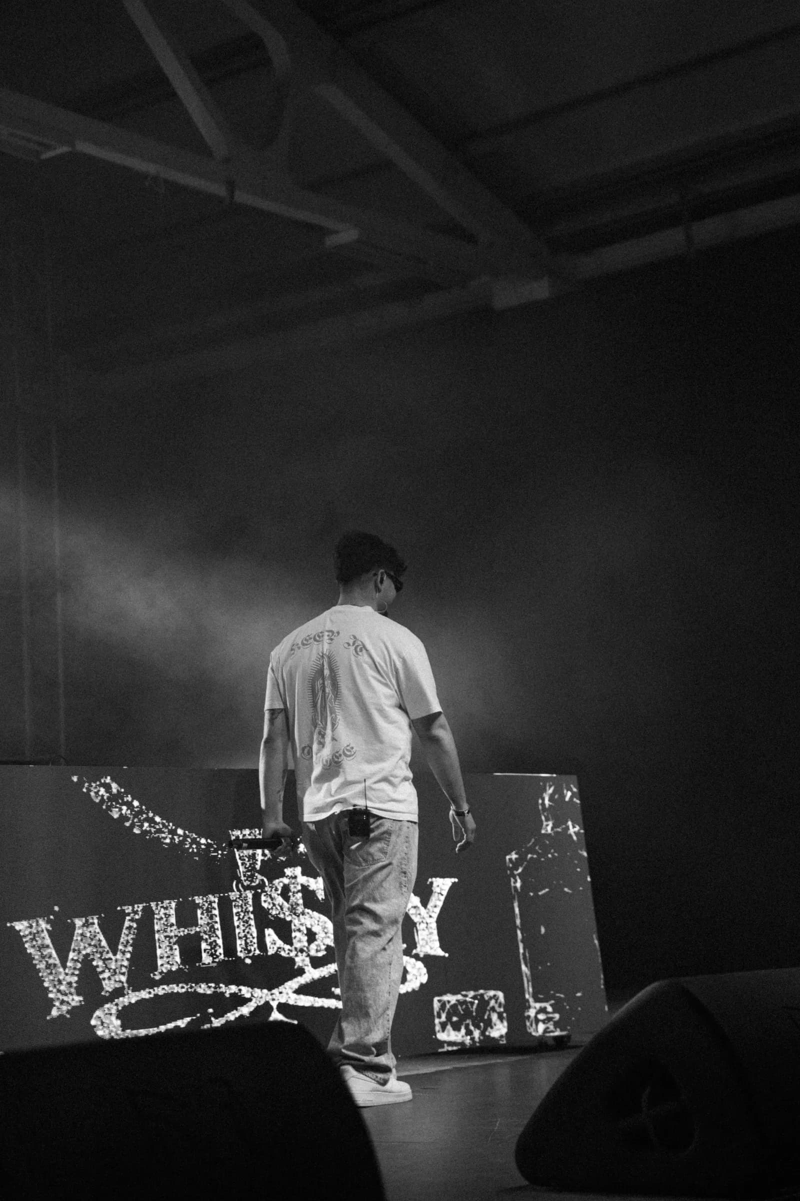 WHI$KY facing the screen with his logo on stage