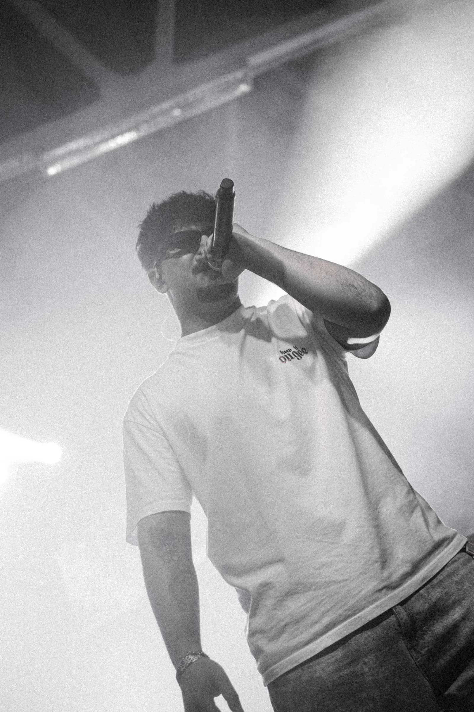 WHI$KY singing into the mic, black and white